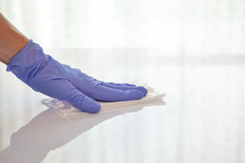 surface disinfecting home cleaning with sanitizing antibacterial wipes protection against covid-19 spreading wearing medical blue gloves sanitize surfaces prevention in hospitals and public spaces