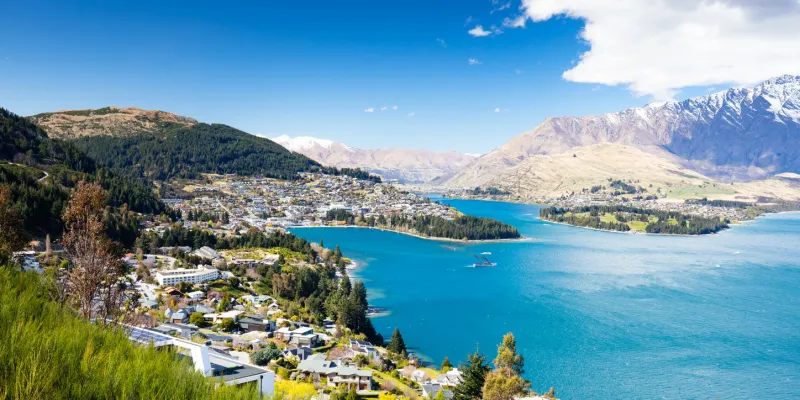a view of queenstown on a sunny spring day in new zealand