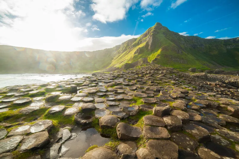 the giant's causeway at dawn on a sunny day with the famous basalt columns, the result of an ancient volcanic eruption county antrim on the north coast of northern ireland, uk