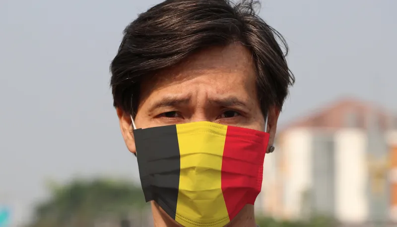 belgium flag on hygienic mask masked man prevent germs concept of tiny particle protection or virus corona or covid19