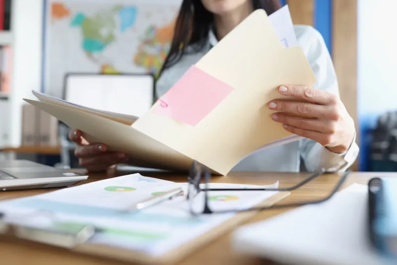 woman is studying financial business documents at her desk business reporting concept