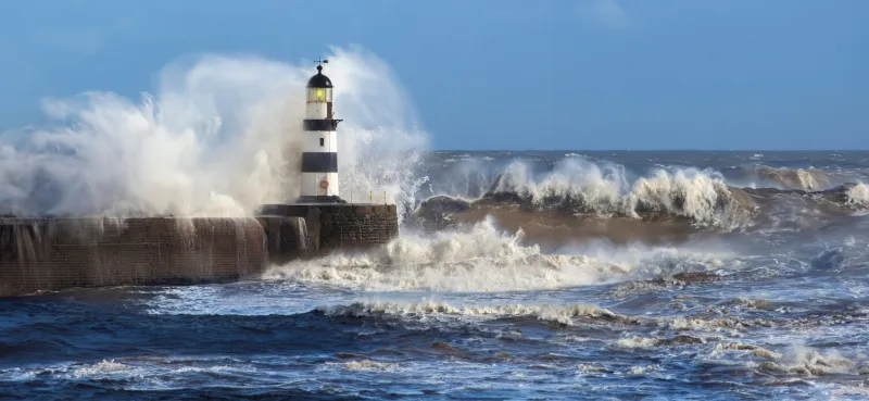 waves crashing over seaham lighthouse on the northeast coast of england