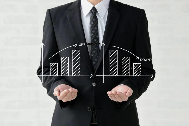business man showing upward and downward chart