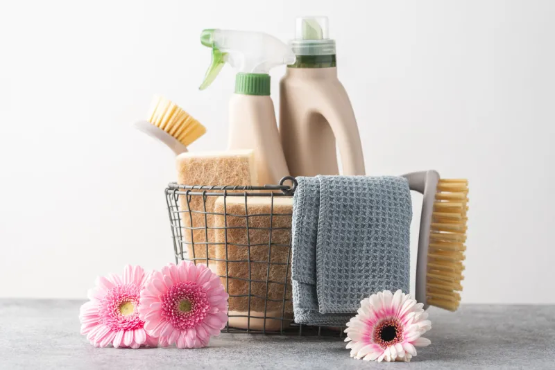 brushes, sponges, cleaning cloth and natural cleaning products in the basket