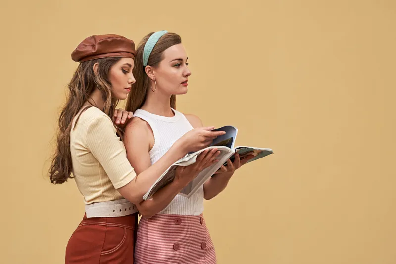 young beautiful girls dressed in retro vintage style enjoying the old european city summertime lifestyle