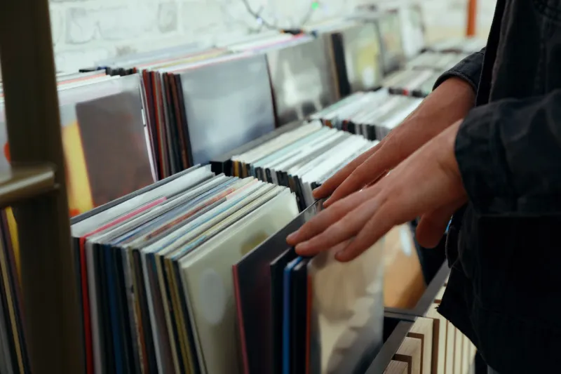 man choosing vinyl records in store, closeup