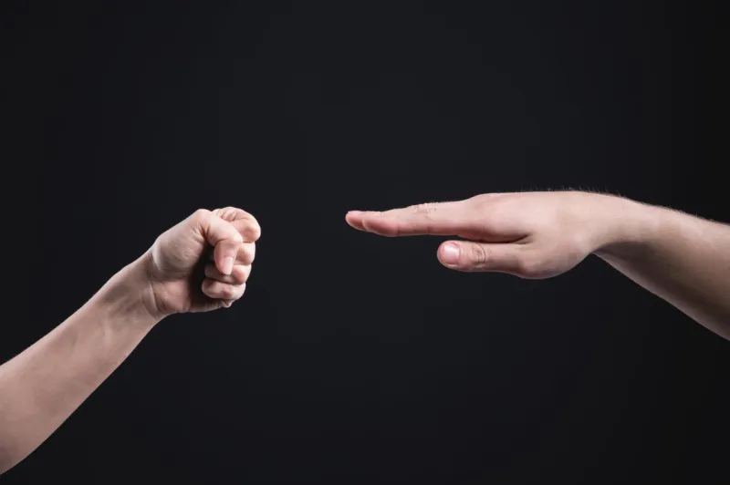game stone paper scissors on a dark background the male and female hand are competing business competition