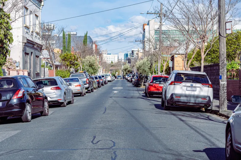 kerbside parking with cars on both sides of the kerbs on a one way road
