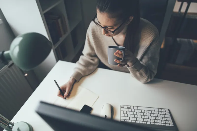 young businesswoman easing working long hours with coffee at her home office