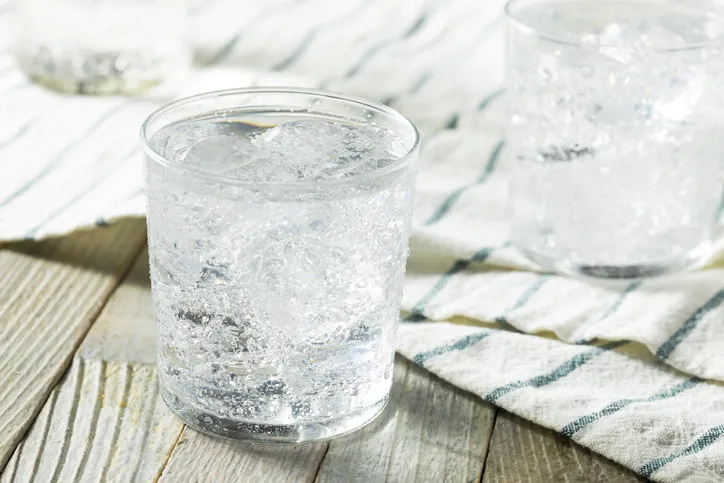 fresh spring sparkling water with ice in a glass