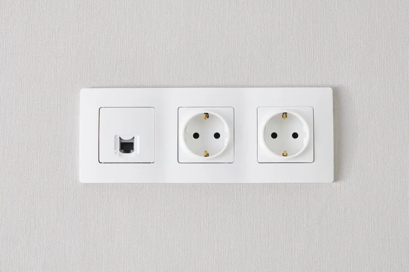 electrical and ethernet white socket on the wall close up