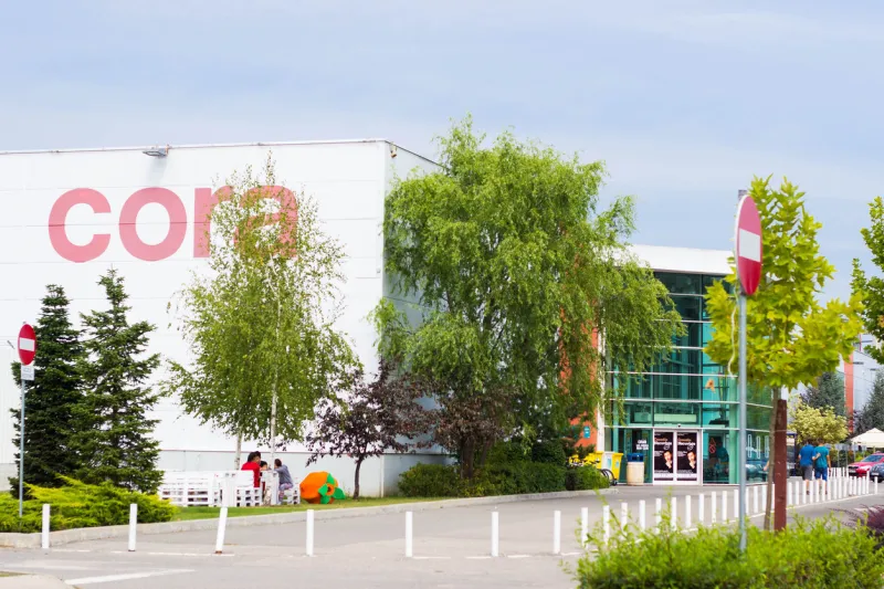 cluj-napoca, romania - september 6, 2014  cloudy view at main entrance of hypermarket cora in transylvania