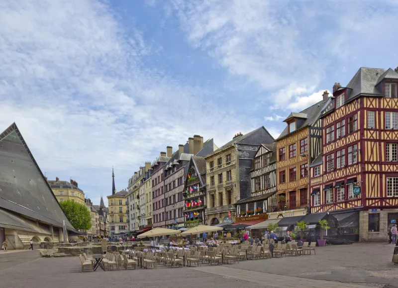 rouen, france – may 15, 2017  place du vieux marche with historical half-timbered buildings and people