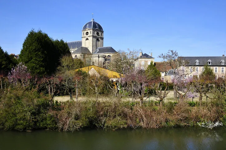 sarthe river bank and bell tower of basilica notre dame at alençon of the lower normandy region in france