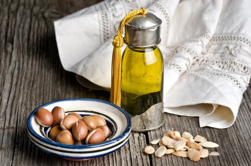 bottle of argan oil and argan fruit argan oil is used for skincare products