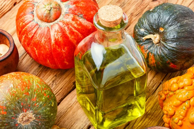 pumpkin oil and raw pumpkinbowl of pumpkin seed oil