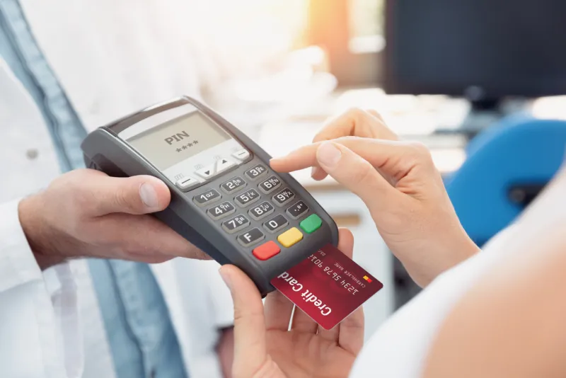 payment by credit card with terminal woman enters the pin code