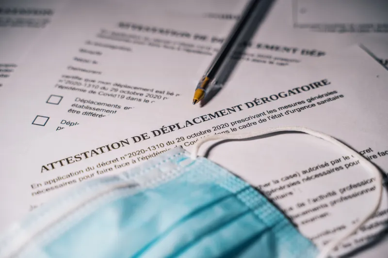 french derogatory travel certificate with pen and surgical mask contravention, police