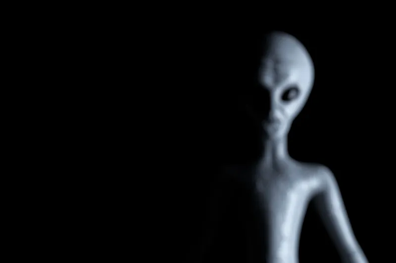 blurred background scary gray humanoid alien on a black background 3d rendering