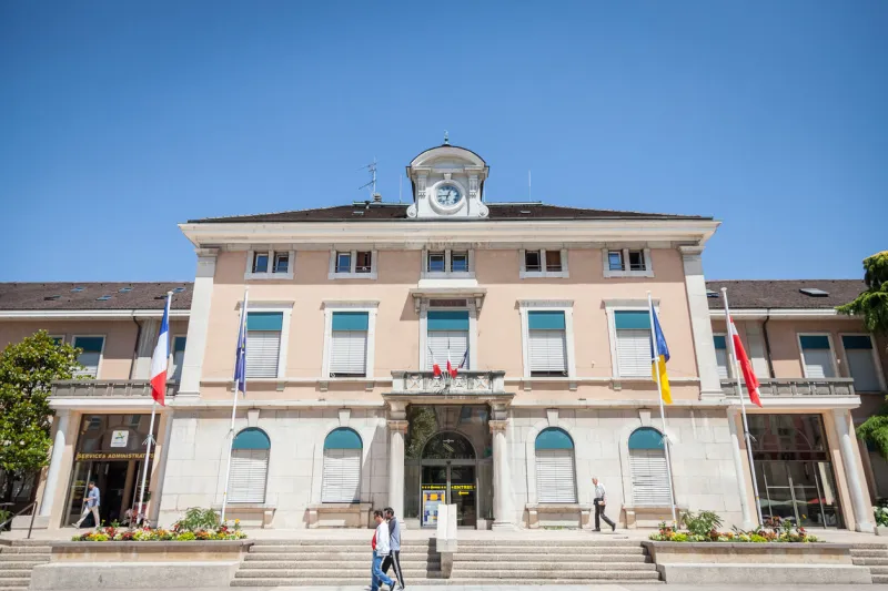 people passing by the mairie d annemasse city hall, a major landmark of the city, in haute savoie, by the swiss border a center of local politics