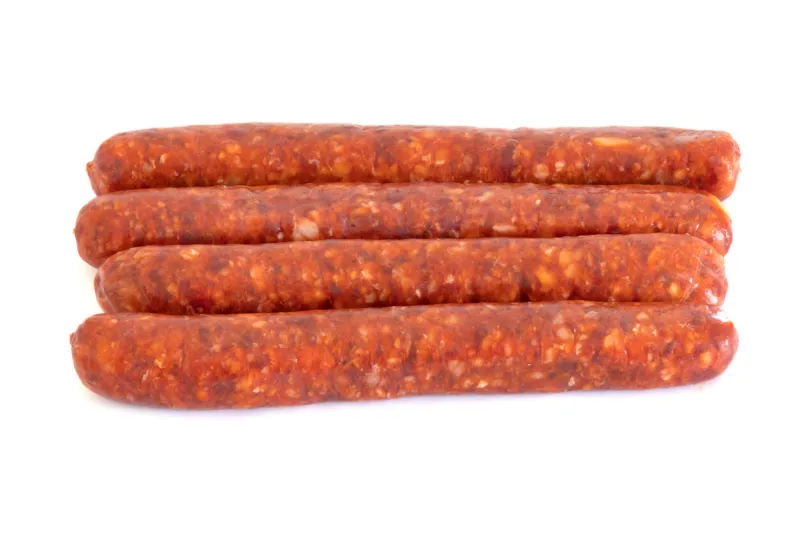 raw merguez on a white background