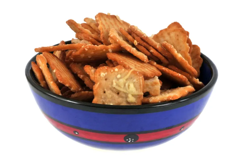 cheese crackers in a bowl in close-up and on a white background