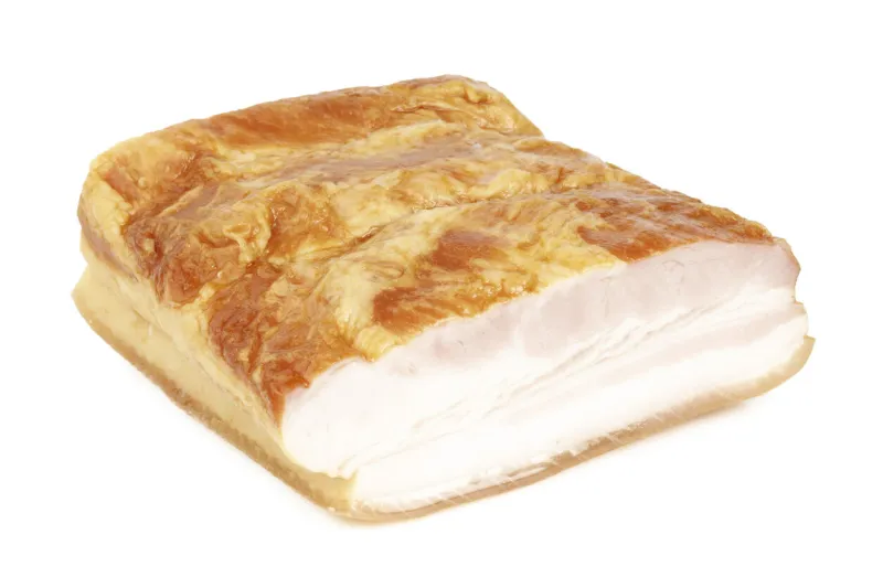 a piece of smoked bacon on a white background, pork belly