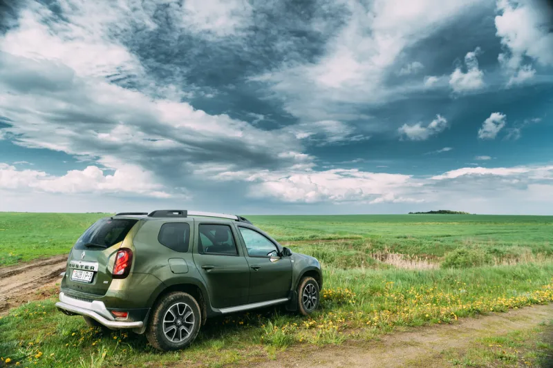 gomel, belarus - may 11, 2019  renault duster suv in spring field countryside landscape duster produced jointly by french manufacturer renault and its romanian subsidiary dacia