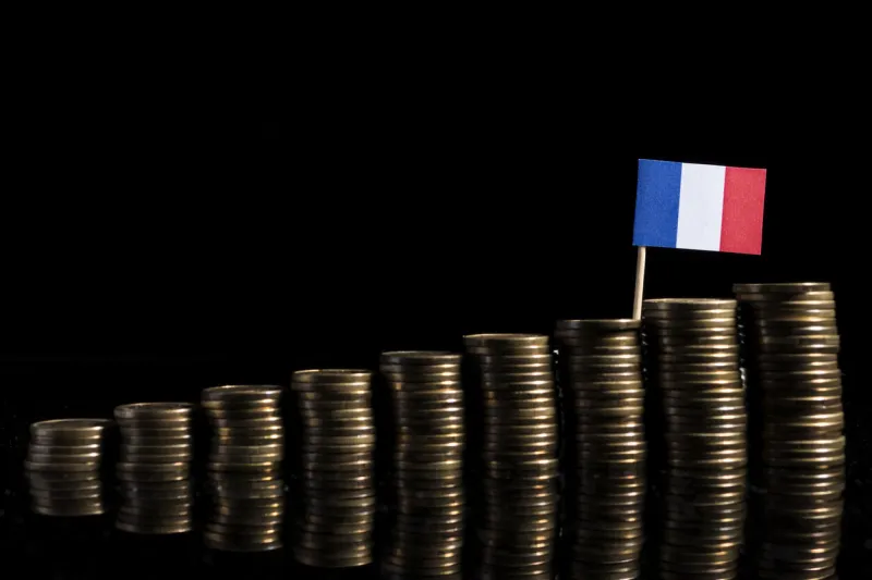 french flag with lot of coins isolated on black background