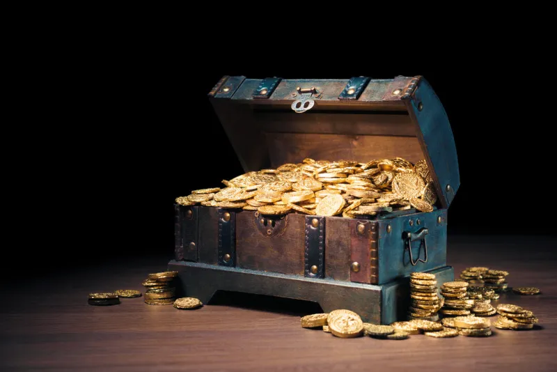 open treasure chest filled with gold coins   high contrast image