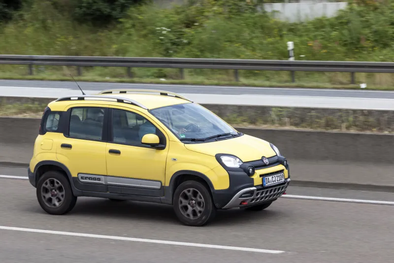 frankfurt, germany - july 12, 2016  yellow fiat panda cross suv driving on the highway