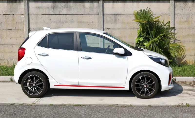 udine, italy may 13, 2022 kia picanto, city car of the south korean automaker, on concrete wall background side view
