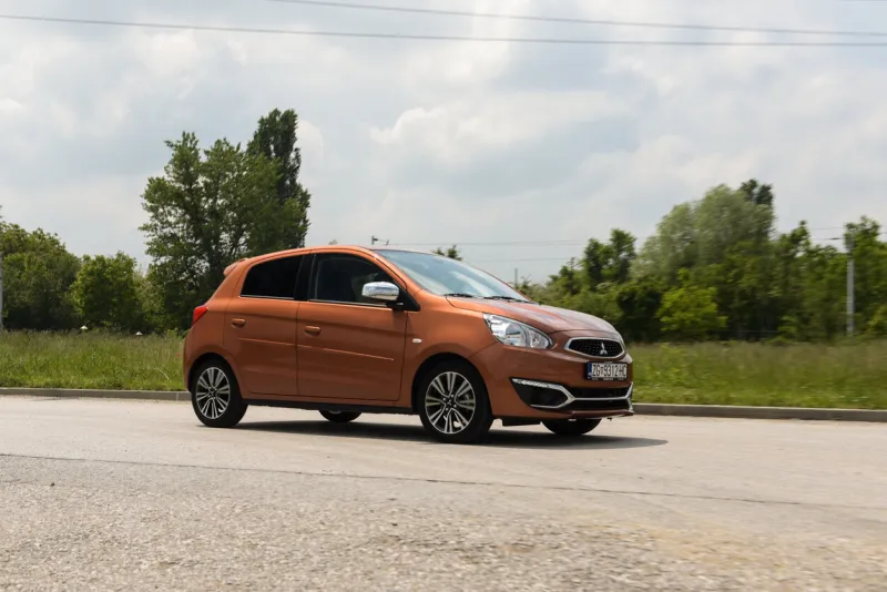zagreb, croatia - may 18, 2019  new mitsubishi space star in orange colour brand new 2019 model parked on the street with blue sky and white clouds in the background