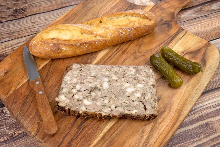 slice of pâté de camapgne and baguette of bread