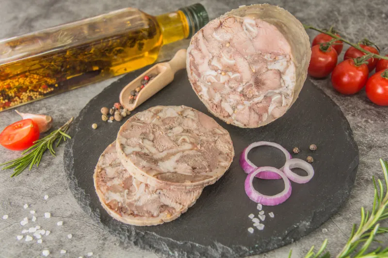 headcheese is a pressed pressed piece of meat cut on black slate