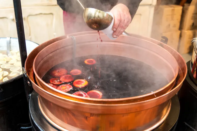 christmas market and a pot of mulled wine with fruit and spices