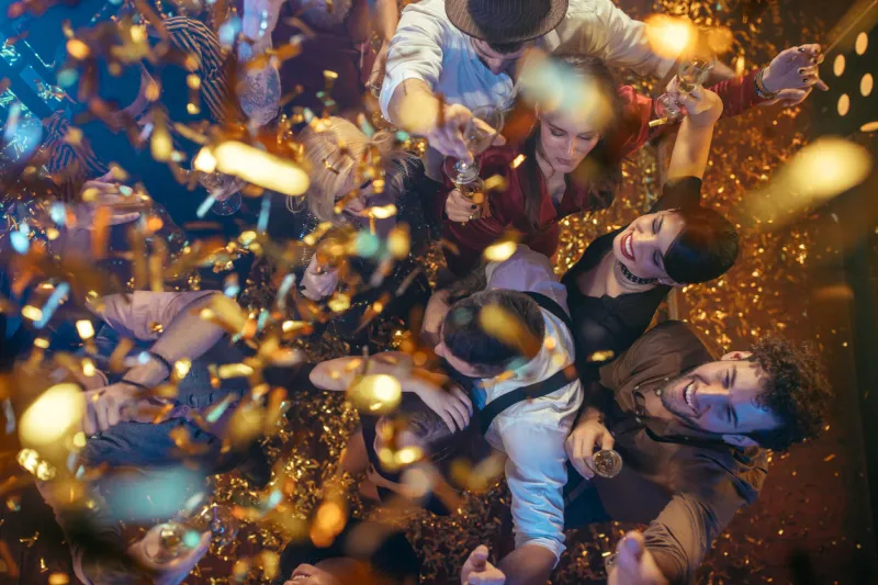 group of friends partying in a club and moving to the music