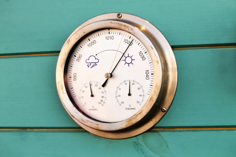 photo of a traditional weather dial on a wall