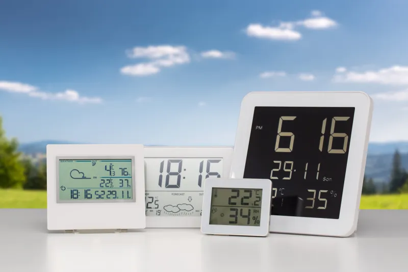 weather station device with weather conditions outside background