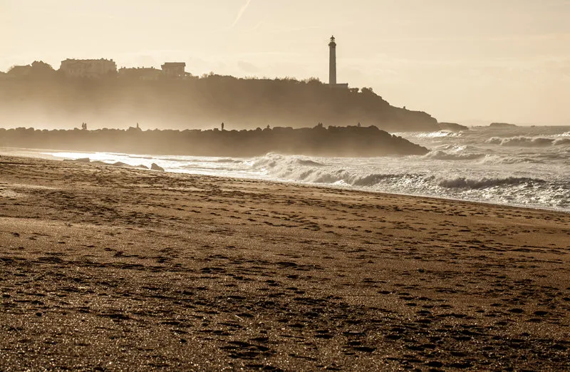 view of biarritz lighthouse from la chambre d'amour in anglet