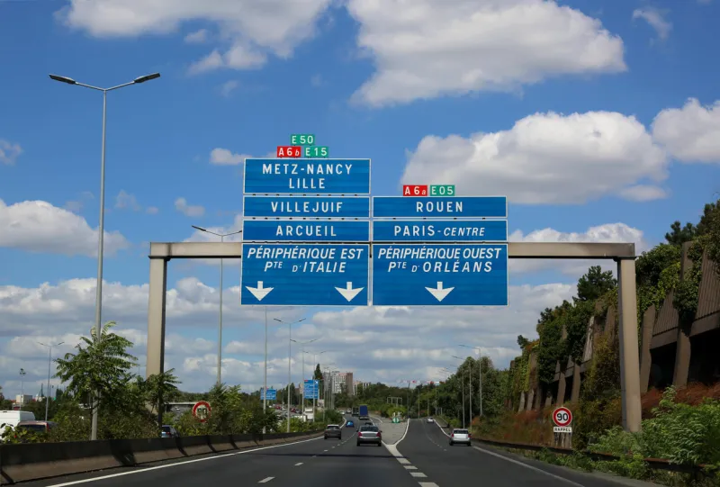 big road signs of the busy french highway that reaches paris and other cities in france