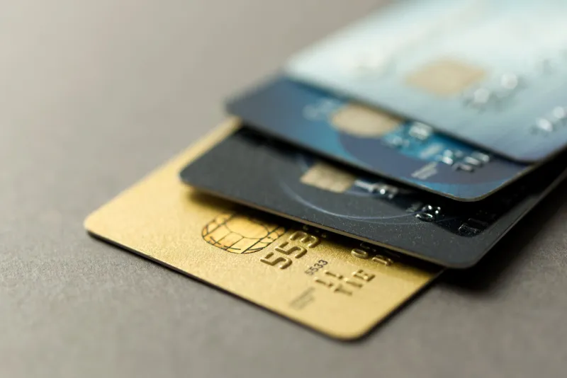 close up of credit cards over grey background