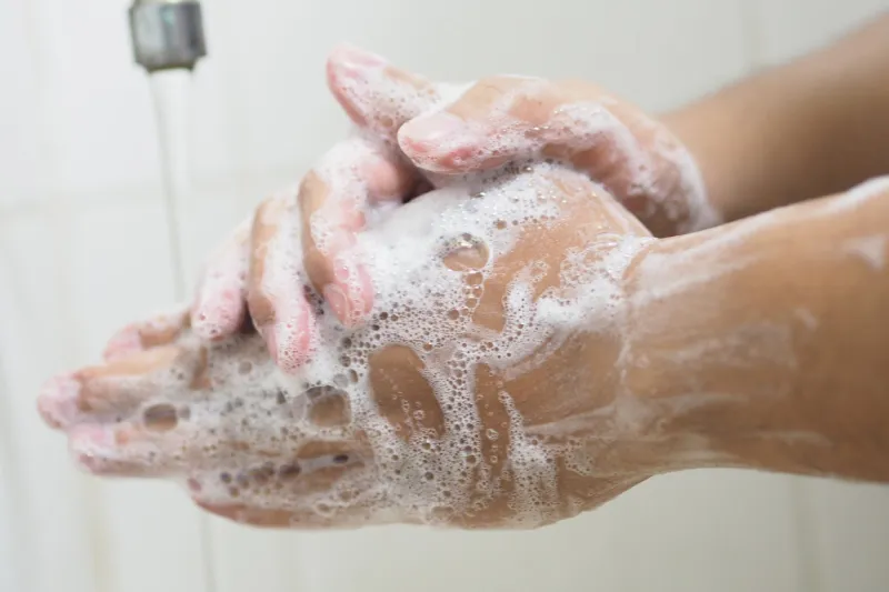 close up of medical staff washing hands hand hygiene
