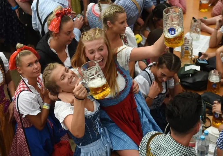 visitors drink beer during the 185th oktoberfest, munich's annual beer festival, on september 22, 2018 in munich, southern germanythe world's largest beer festival is held from september 22 until october 7, 2018   afp photo   christof stache