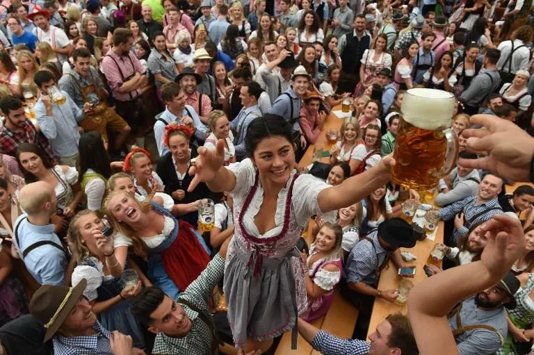 visitors drink beer during the 185th oktoberfest, munich's annual beer festival, on september 22, 2018 in munich, southern germanythe world's largest beer festival is held from september 22 until october 7, 2018   afp photo   christof stache