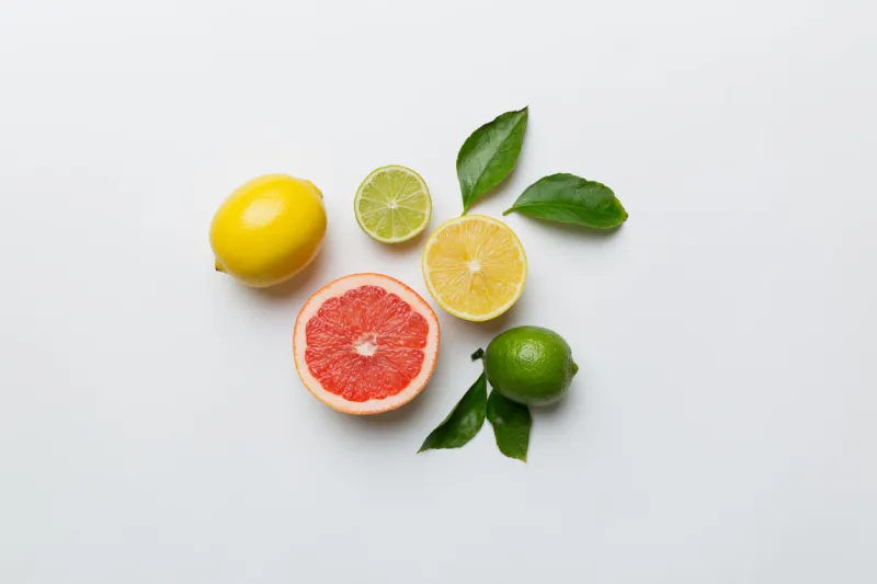 fruit background colorful fresh fruits on colored table orange, lemon, grapefruit space for text healthy concept flat lay, top view, copy space