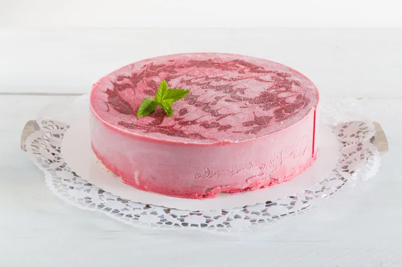 raspberry ice cream cake on white rustic wood