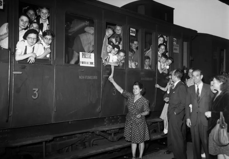 a group of children wait for the departure of their train on july 19, 1947 at the gare de l'est in paris, as they go to a summer camp in the black forest in germany, thanks to the social works of the paris press syndicate (photo by -   afp)