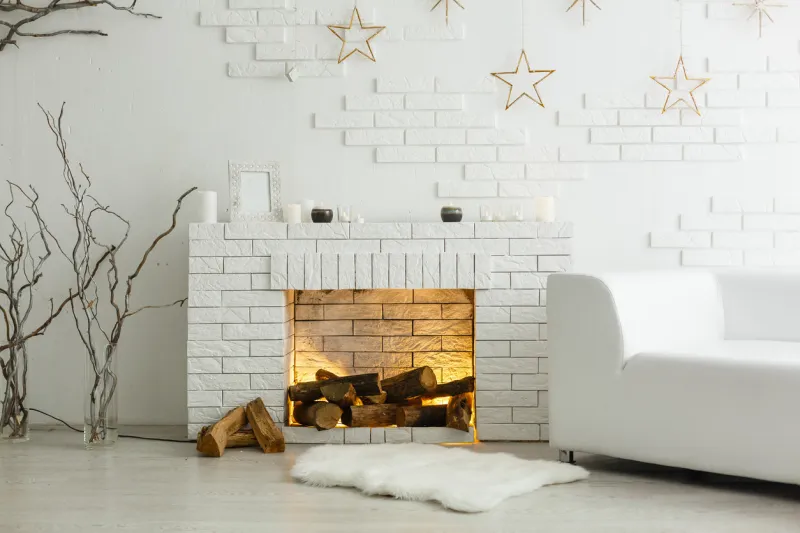 white fireplace in light room with christmas decoration