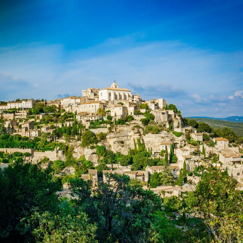 village of gordes in the luberon valley in provence, france, on a summer day with blue sky